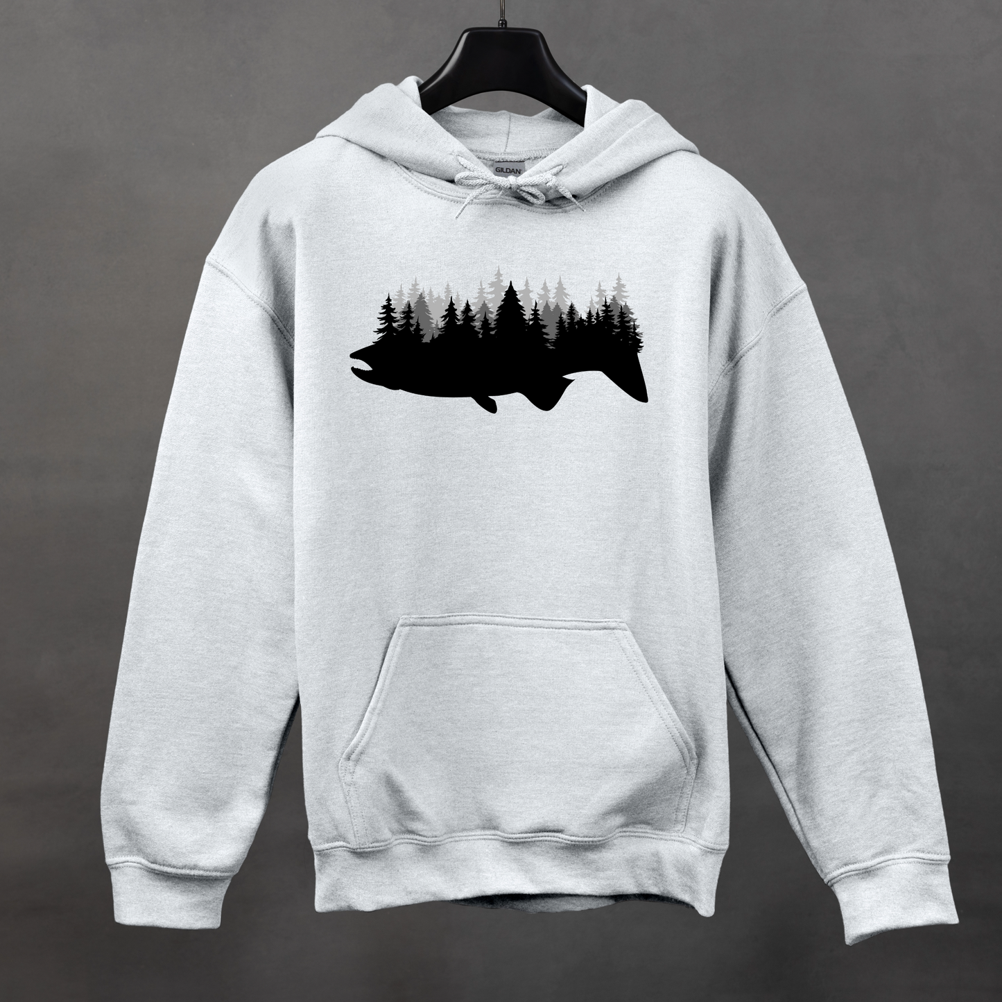 A gray hoodie with a silhouette of a fish filled with a forest design on the front.