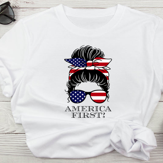 classic t-shirt with messy bun silhouette, red, white, and blue hair bow and sunglasses, and America First text in black below.