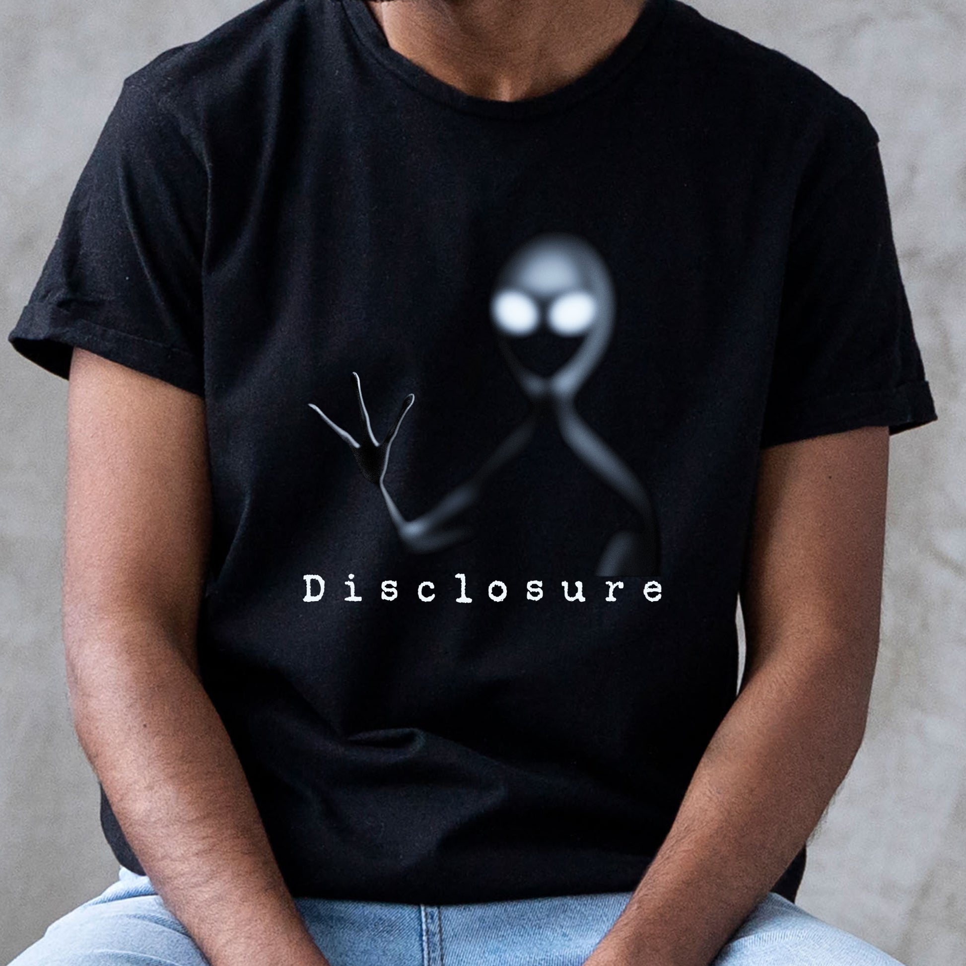 classic black t-shirt depicting a white alien shadow figure reaching out with the word Disclosure underneath.